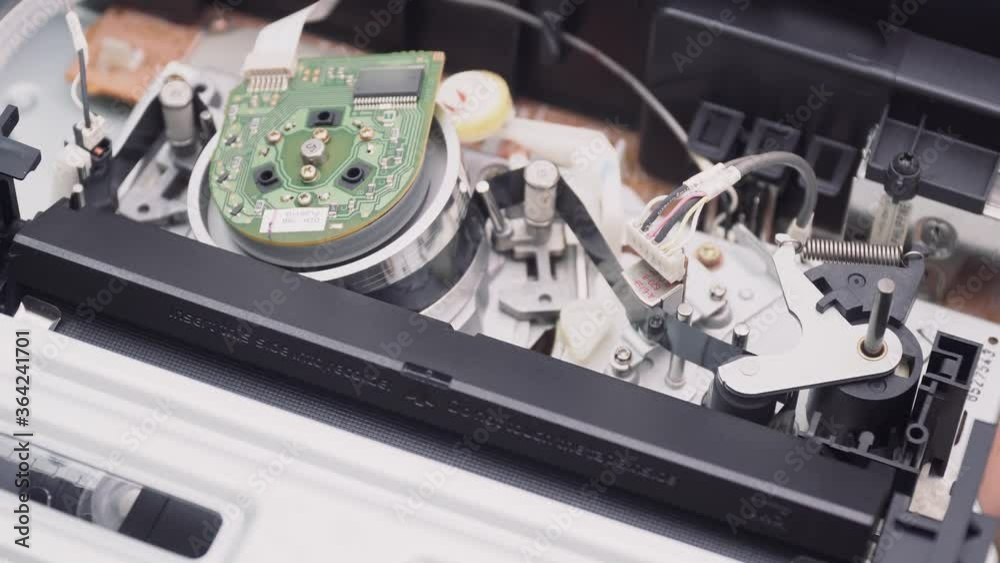 Closeup a VHS video cassette recorder tape loading. VHS mechanics