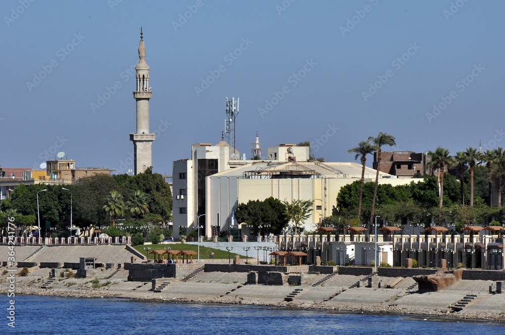 Panorama of the Nile promenade with a pier for ships in the city of Luxor, Egypt. View from the deck of a pleasure boat.
