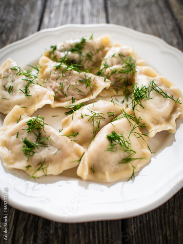 Dumplings - noodles with meat on wooden table