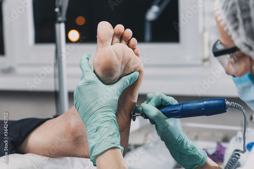 Peeling feet pedicure procedure in a beauty salon.