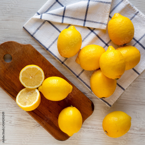 Ripe Yellow Organic Lemons on a white wooden background, top view. Flat lay, overhead, from above.