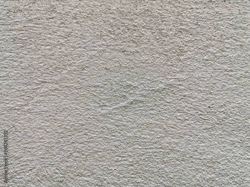 The rough surface of the cement wall is not painted.