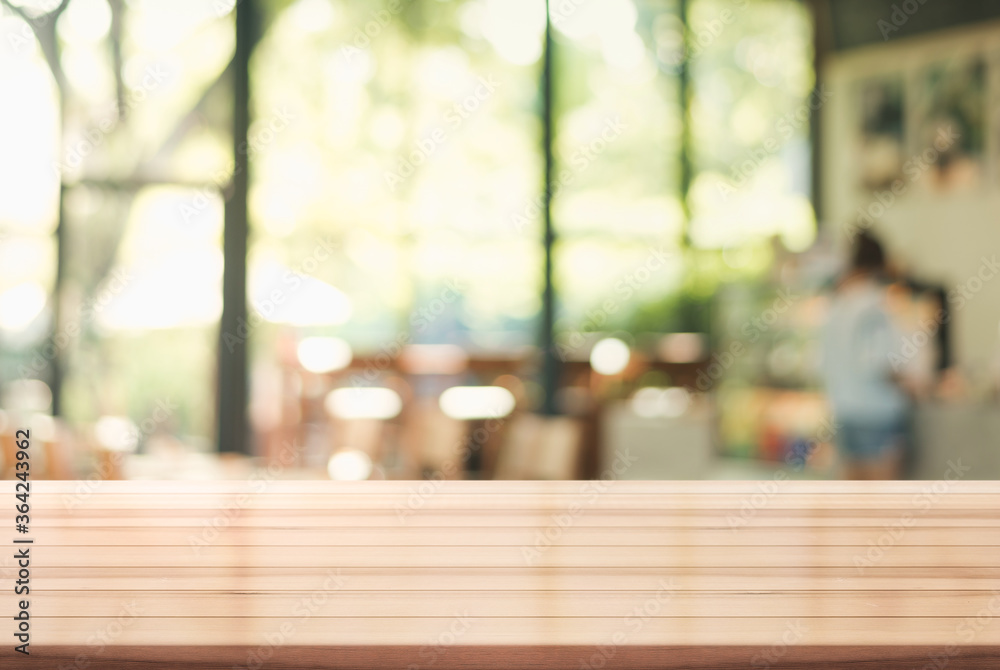 Empty wooden top table with blur coffee shop background