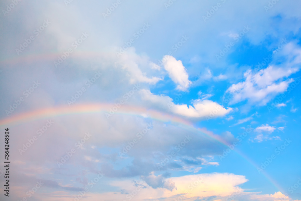 Double Rainbow High in the Clouds . Natural Phenomenon with Rain and Sun