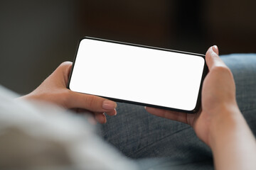 Leinwandbilder Schwarz Young woman hold smarphone with white screen while sitting in a chair  © GCapture