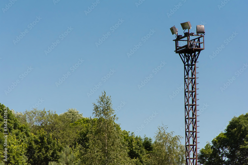 metal tower with spotlights for lighting and territory protection