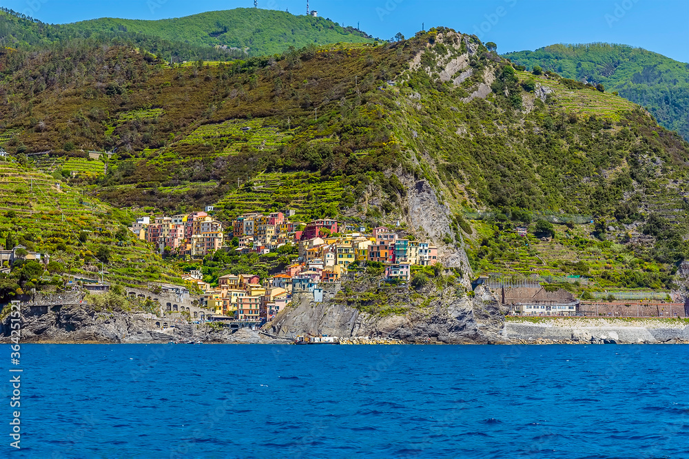 A view from the sea towards the Cinque Terre village and station of Manarola, Italy in the summertime