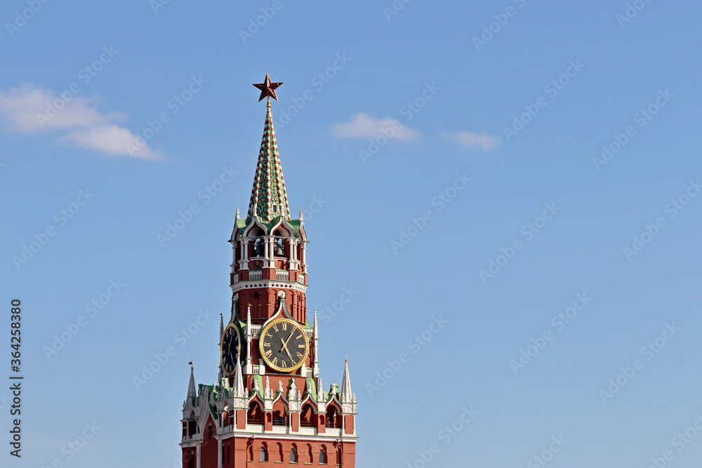 Chimes of Spasskaya tower, symbol of Russia on Red Square. Moscow Kremlin tower isolated on blue sky background
