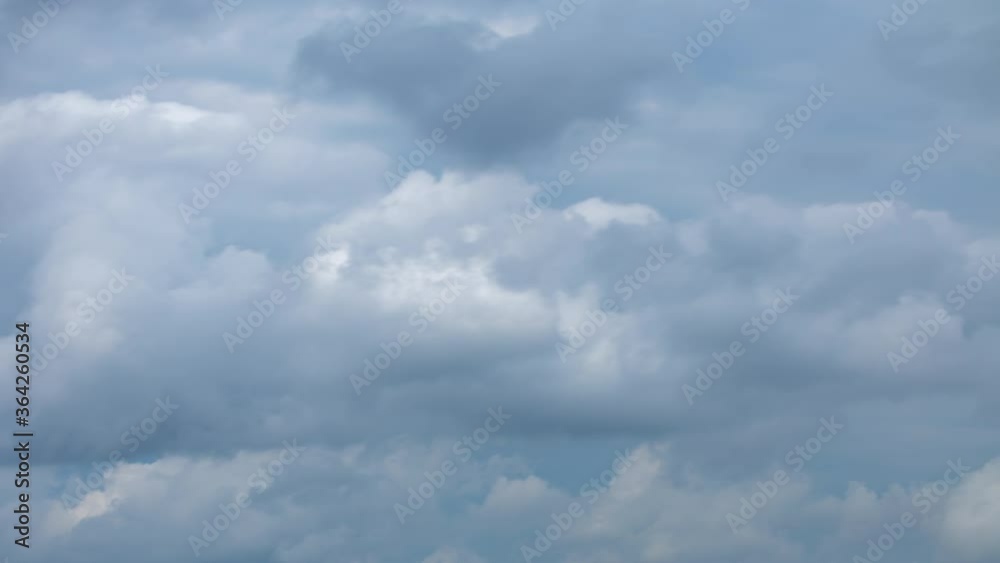 Fluffy rain clouds moving fast in time-lapse. Evening, cloudy heaven background. Timelapse of beautiful clouds in the sky, dramatic storm cloud overhead Fluffy rain clouds moving fast in time-lapse. Evening, cloudy heaven background. Timelapse of beautiful clouds in the sky, dramatic storm cloud overhead