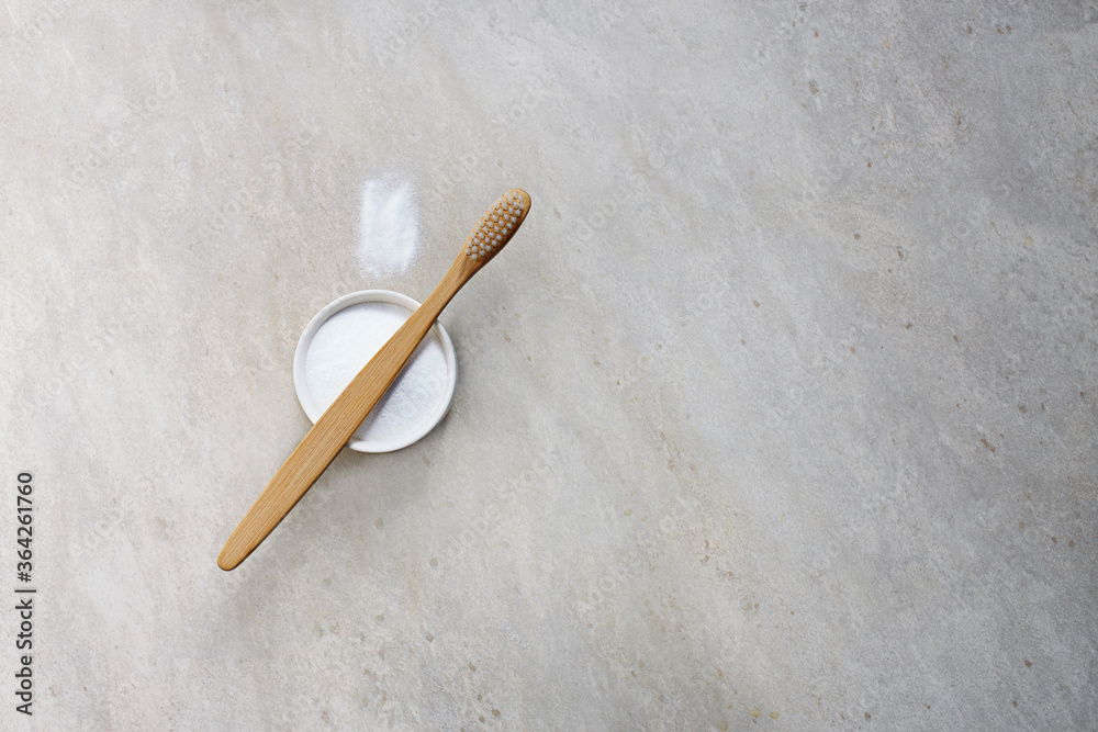 Bamboo toothbrushe and powder for brushing your teeth in bowl on light gray backdrop. No plastic, zero waste concept. Bamboo toothbrushe and powder for brushing your teeth in bowl on light gray backdrop. No plastic, zero waste concept.