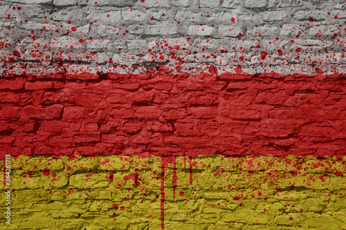 painted big national flag of south ossetia on a massive old brick wall © luzitanija