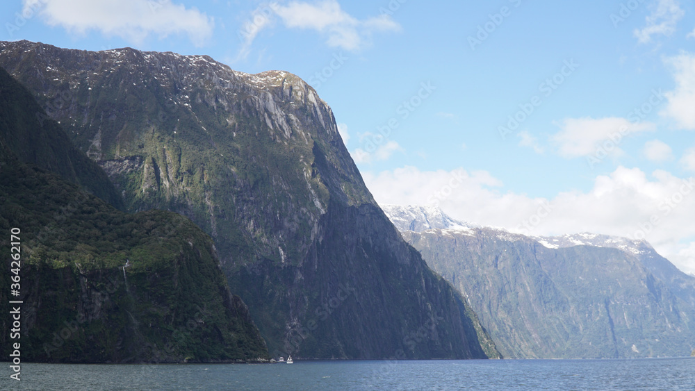 Steep mountain cliffs in Milford Sound Fiordland National Park, New Zealand.