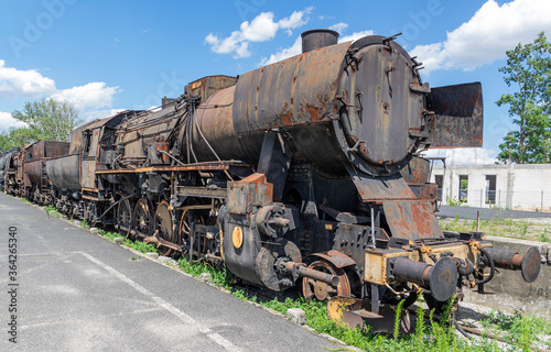 Old, rusty abandoned train. Corroded vintage locomotive