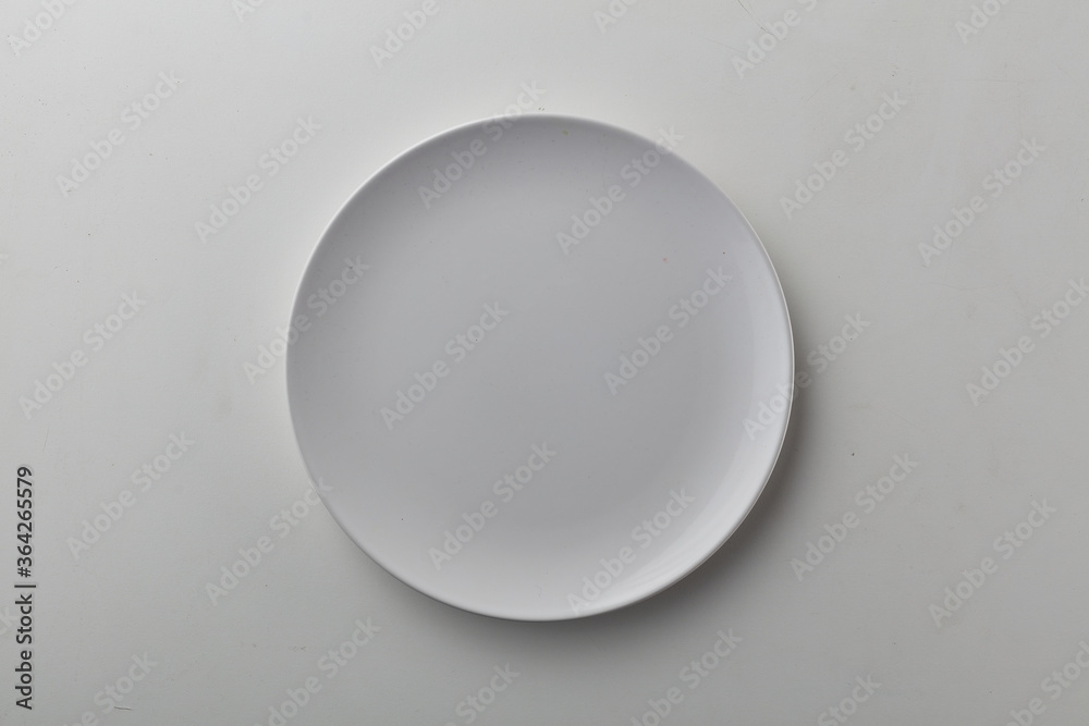 Top view shot of white circular plate. Top view shot of white circular plate.