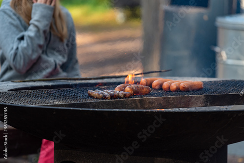 sausages on the grill at a barbeque at the park in Finland