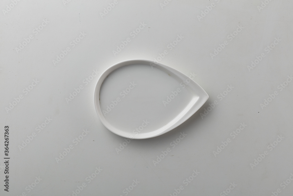 Top view shot of a rectangular white plate on white background. Top view shot of a rectangular white plate on white background.
