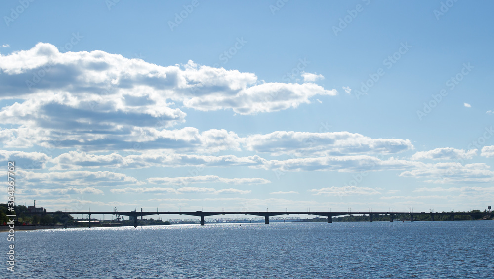 River and sky with cloud. Summer landscape with a view of the wide river. City embankment, view of the other Bank.