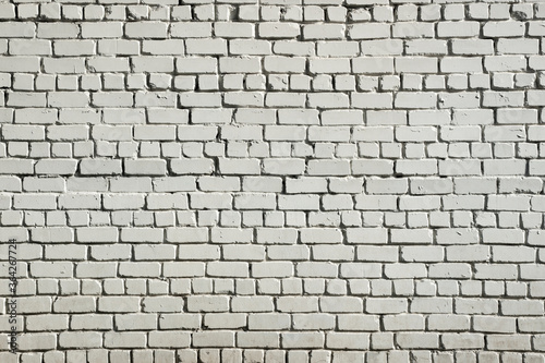 White brick wall background. A brick wall of rough white brick. Brutal abstract grunge background.
