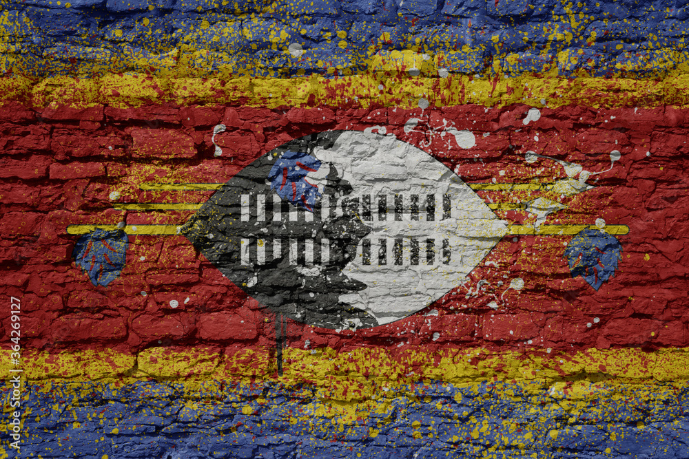 Fototapeta premium painted big national flag of swaziland on a massive old brick wall