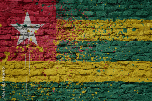 painted big national flag of togo on a massive old brick wall