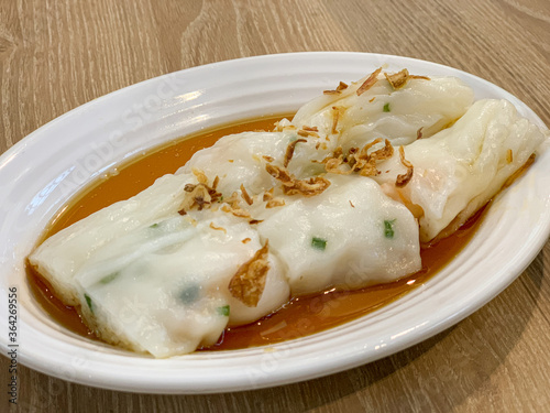 Chee Cheong Fun - Chinese steamed rice rolls with dried shrimp and spring onion served with hoisin sauce, soybean paste and chili dip. photo