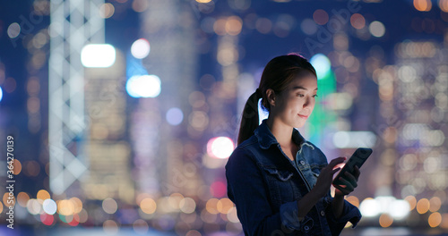 Photography Woman uses mobile phone at night