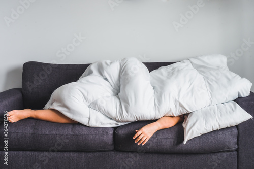 Fotografi Young white woman on modern grey couch