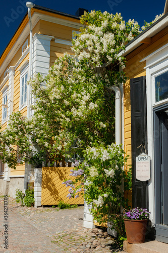 Porvoo, Finland - 3 June 2020: Beautiful street with shops and blooming flowers in old town of Porvoo