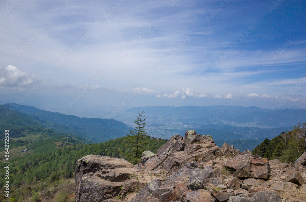 Fototapeta premium View of Kofu basin and cloud ( cirrostratus and cumulus) in a early summer at near Mt.Daibosatsu, Yamanashi Prefecture, Japan.