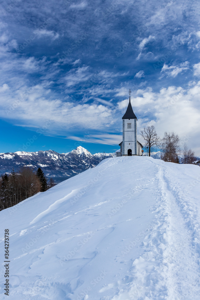 Church of Saint Primus and Felician Jamnik Slovenia winter snow mountain Storžič