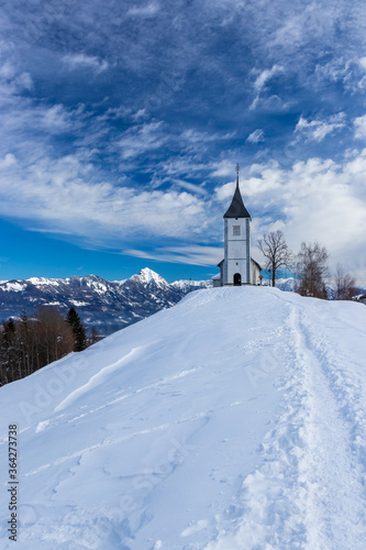 Church of Saint Primus and Felician Jamnik Slovenia winter snow mountain Storžič © Patrik