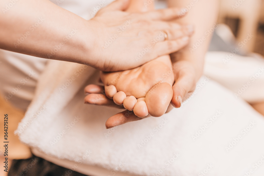 Professional relaxing foot massage - rubbing female feet for blood circulation Professional relaxing foot massage - rubbing female feet for blood circulation