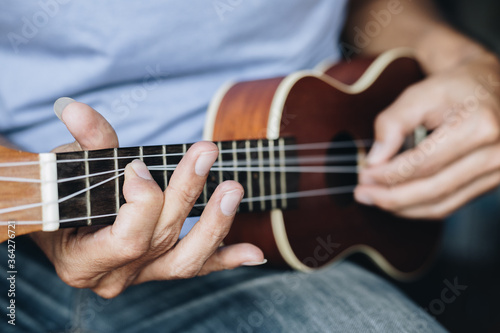 Close up Young man playing ukulele