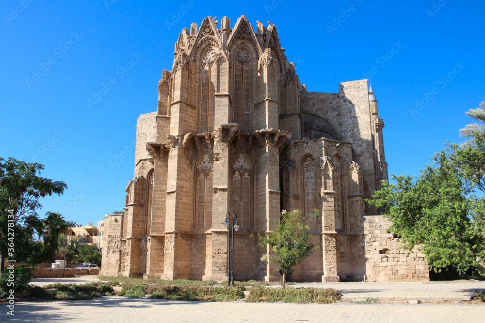 The reverse side of the Lala Mustafa Pasha Mosque (former St. Nicholas Cathedral)against the blue sky. Famagusta. Cyprus.