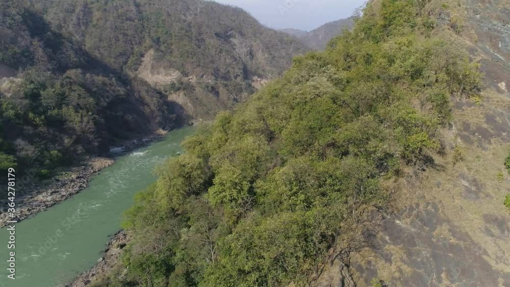 Mountaineers learning how to climb down a steep cliff or slope with the help of Rappelling method, in beautiful hills of Himalayas. Mountaineers learning how to climb down a steep cliff or slope with the help of Rappelling method, in beautiful hills of Himalayas.
