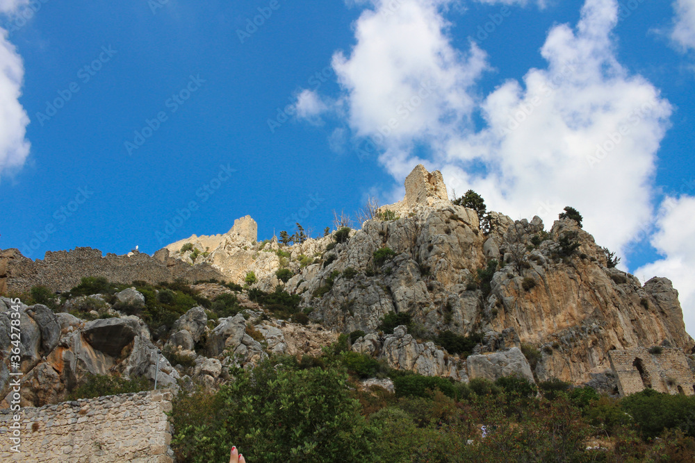  View from below of the sunlit towers of the castle of Saint Hilarion. Cyprus.