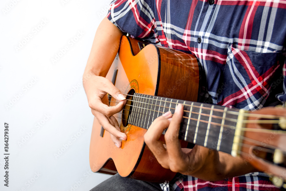 Fototapeta premium Close Up of Man's Hand Playing an Acoustic Guitar