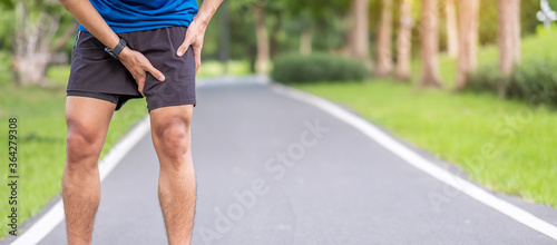 Young adult male with muscle pain during running. runner have leg ache due to Groin Pull. Sports injuries and medical concept photo