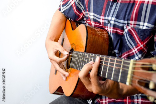 Close Up of Man's Hand Playing an Acoustic Guitar