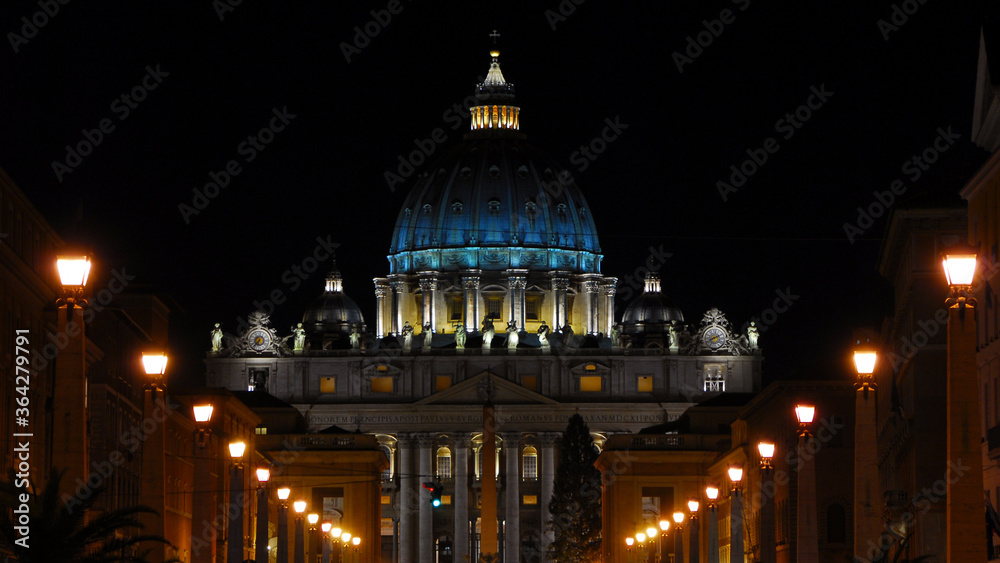 Night in Rome. View of the iconic St Peter dome illuminated, in the city historic center