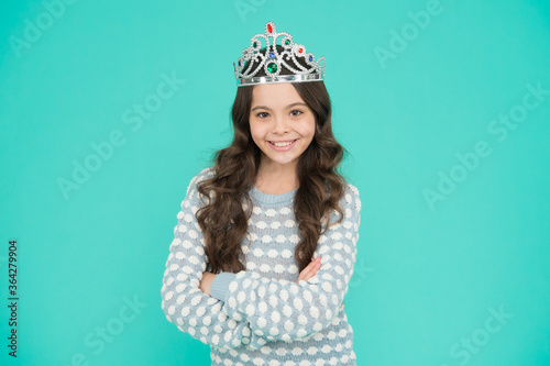 Just look at me. Princess concept. Girl princess. Lady small baby princess. Number one. Kid wear golden crown symbol of princess. Girl cute baby wear crown blue background. Success and happiness