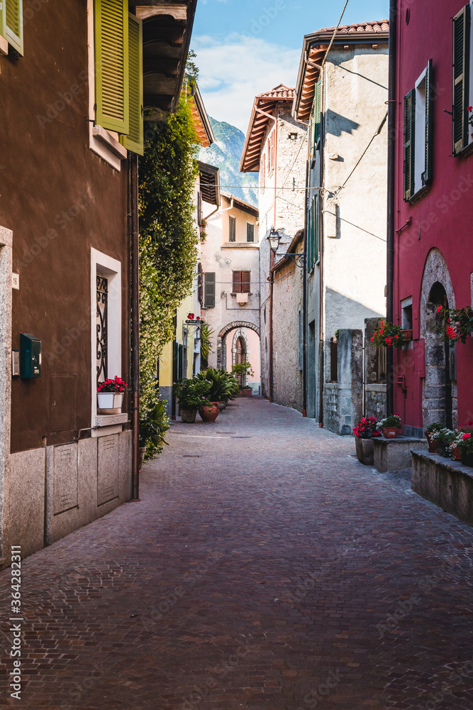 Fototapeta premium Alley with colored houses. Blue sky