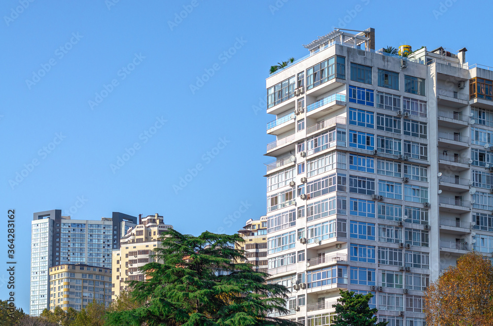 Tall residential building against the background of other buildings