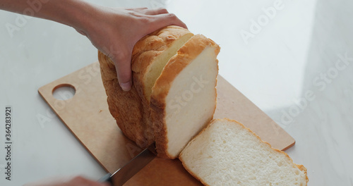 Cut a white bread with knife
