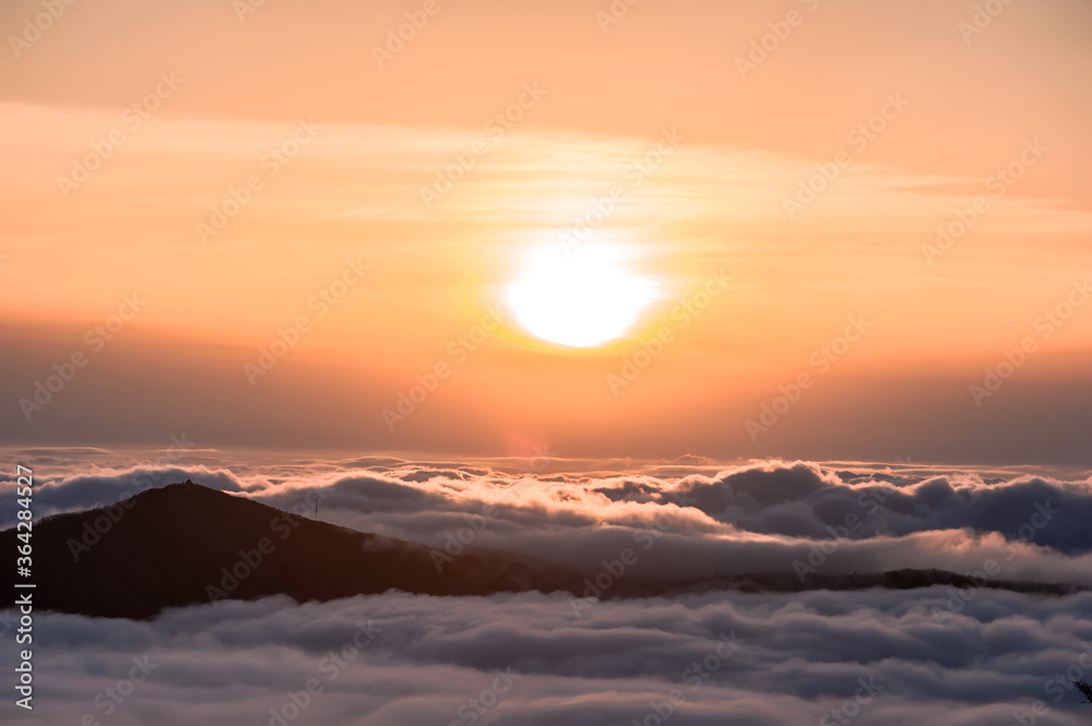 Beautiful sea of clouds at sunset on the top of the mountain.