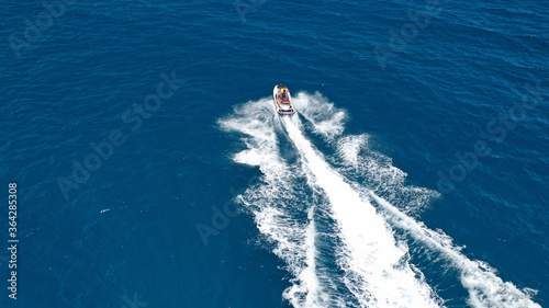 defaultAerial drone photo of stunt man performing extreme stunts with water craft over the ocean at dusk