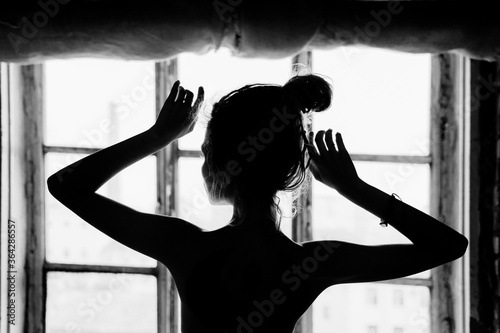 Naked woman near the window