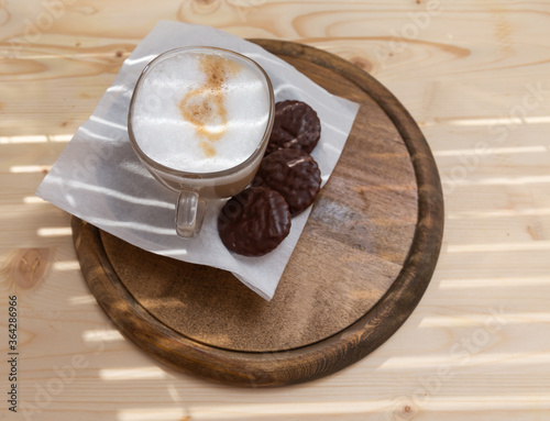 Canvas Print a cup of hot cappuccino and three biscuits