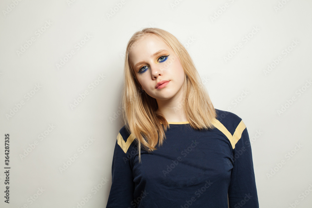 Teenager girl with makeup wearing blue longsleeve on white background Teenager girl with makeup wearing blue longsleeve on white background
