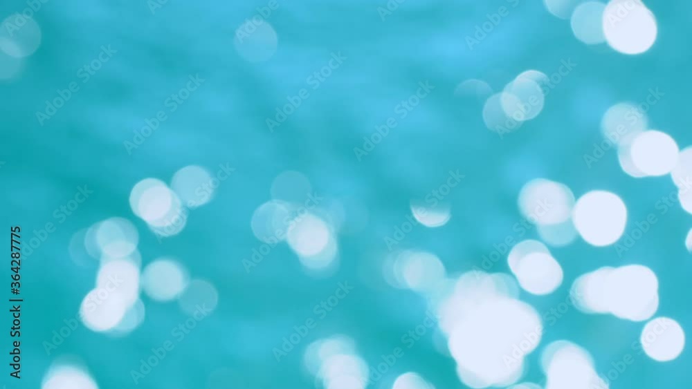 Beautiful sparkling shiny texture of blurry blue water with sun reflected on surface of water Beautiful sparkling shiny texture of blurry blue water with sun reflected on surface of water